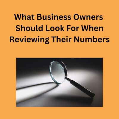 Medium orange background. What Business Owners Should Look For When Reviewing Their Numbers in bold black text. Below a square with black, gray and white, a magnify glass with a silver head and black handle.